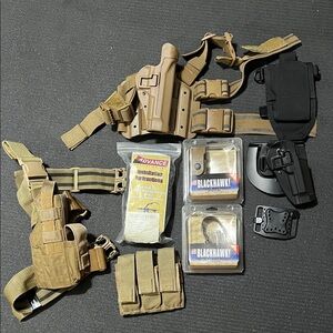 Various new and used holsters and mag pouches